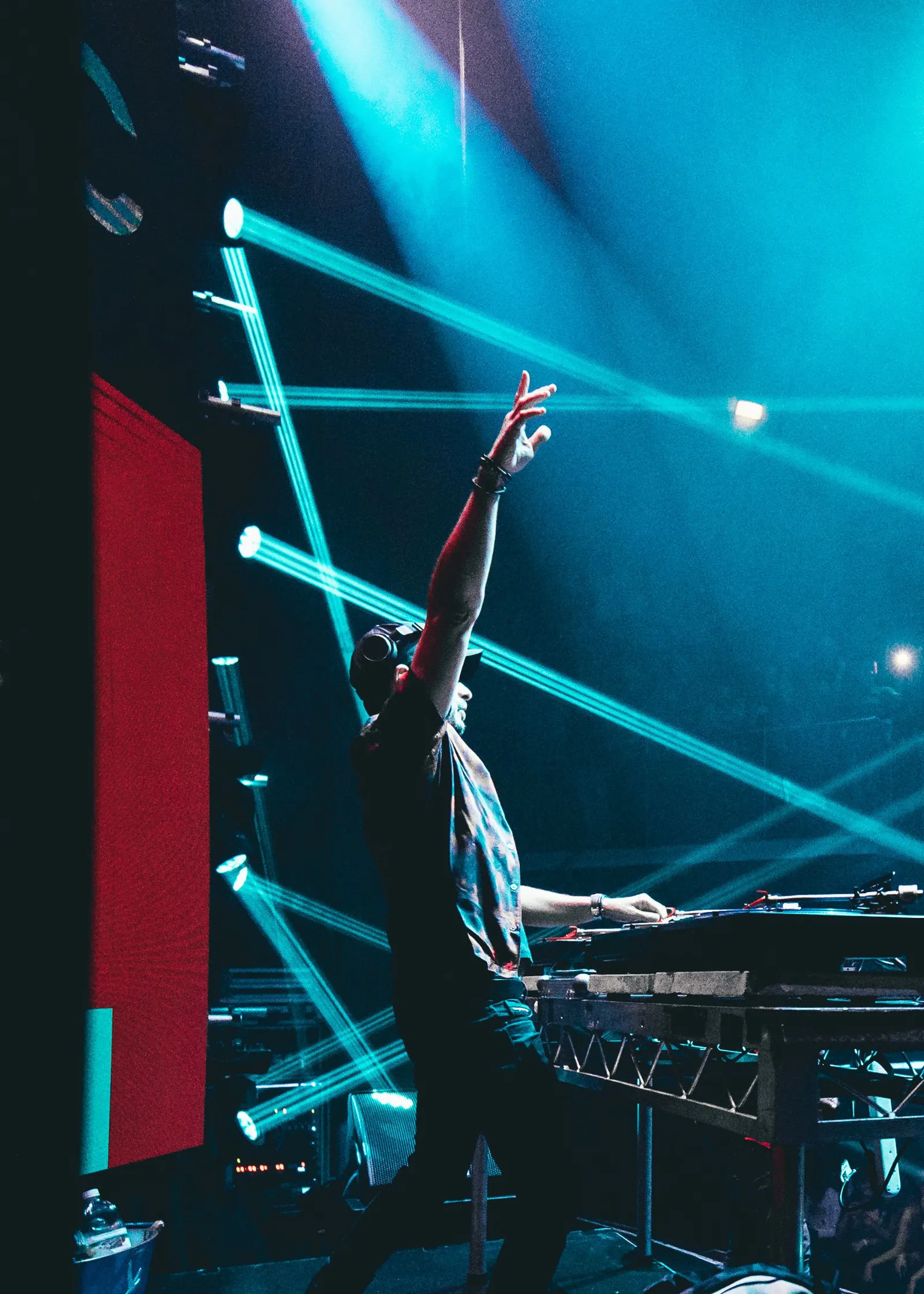A DJ booth under lasers